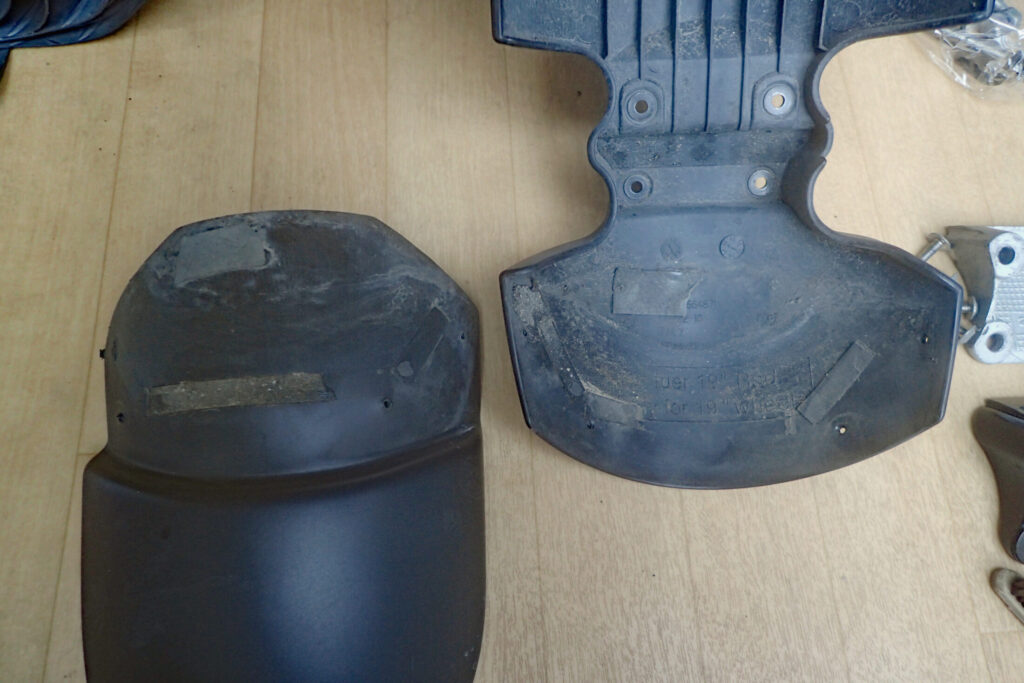 The overlapping bonding surfaces of the BMW G650GS front fender and extender perfectly cleaned and degreased for proper reinstallation.