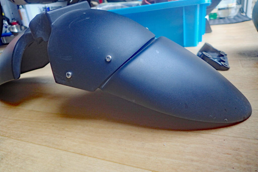 Left side view of the BMW G650GS front fender, showing how the extension mudguard flap was attached unevenly.