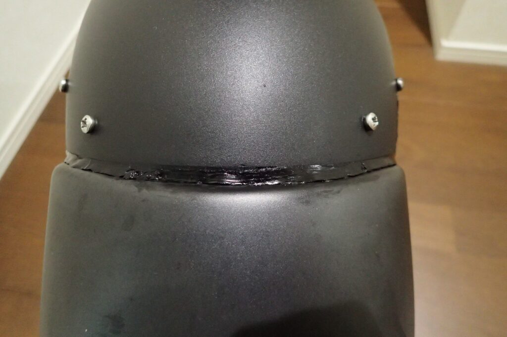 The clean and professional finished outer joint of the motorcycle front fender after removing the masking tape.