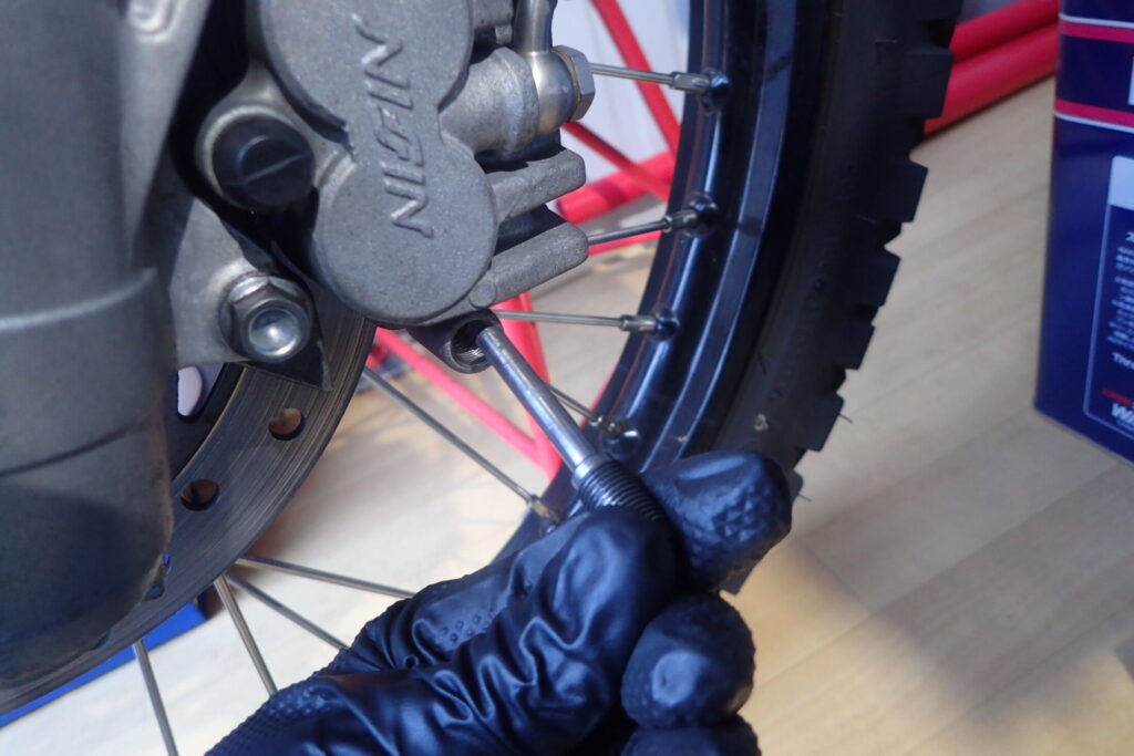 【ピン外し】 ブレーキパッドピンが外れた状態。古いブレーキパッドをキャリパーから抜き取る前の様子。