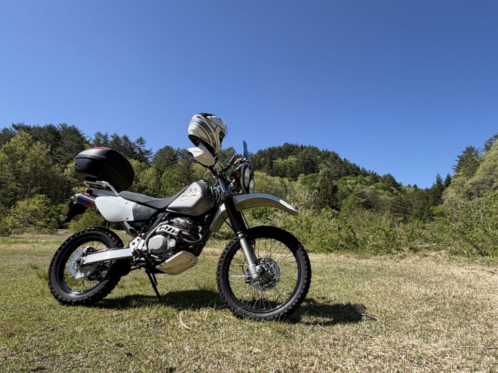 Close-up of the iconic dual headlights of a Honda XR BAJA off-road motorcycle during a touring break.