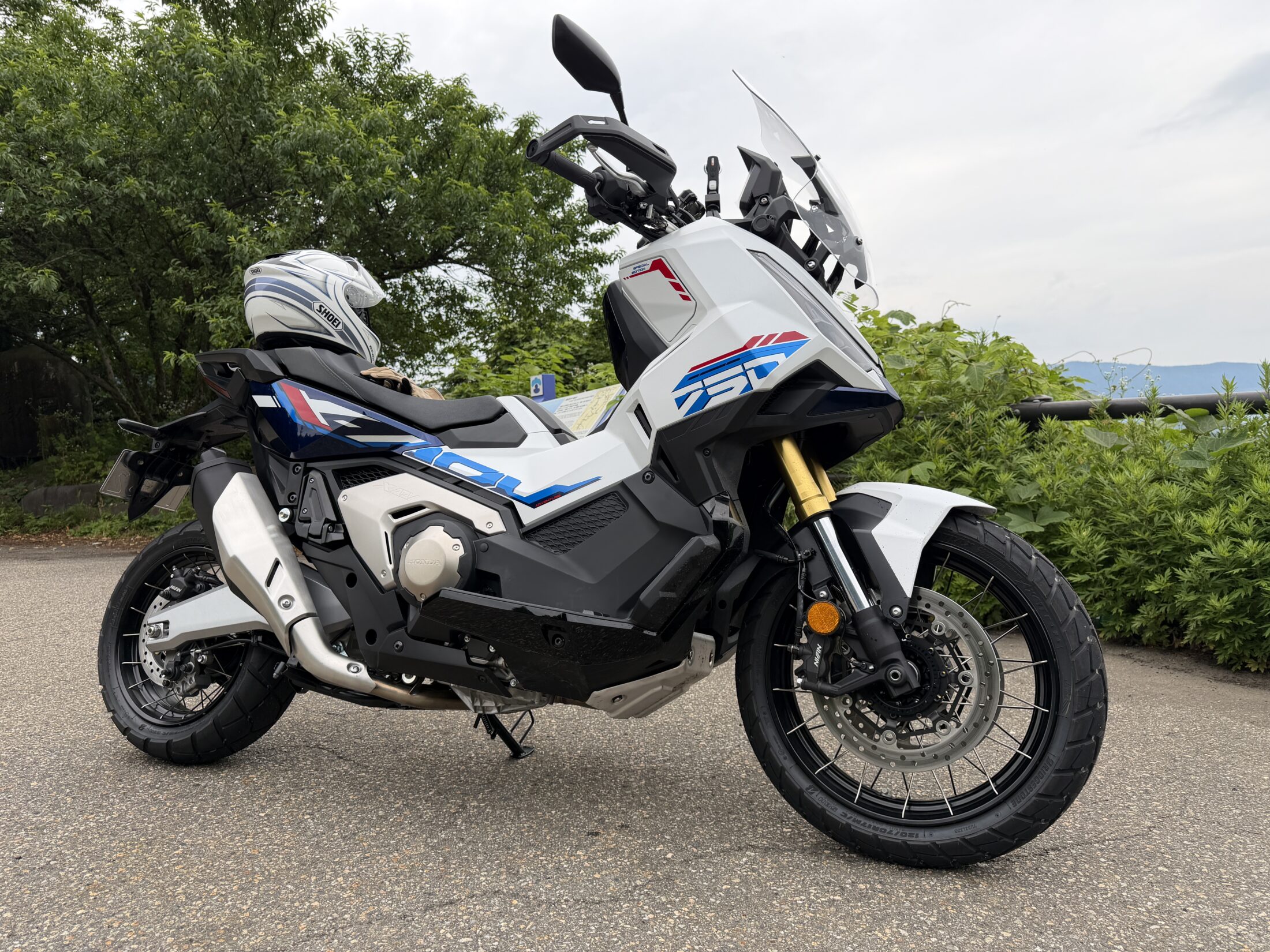 A white and blue Honda X-ADV seen from the front right