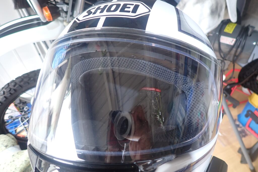 Front view of a perfectly clean and crystal clear SHOEI helmet visor after applying SurLuster Zero Finish coating.