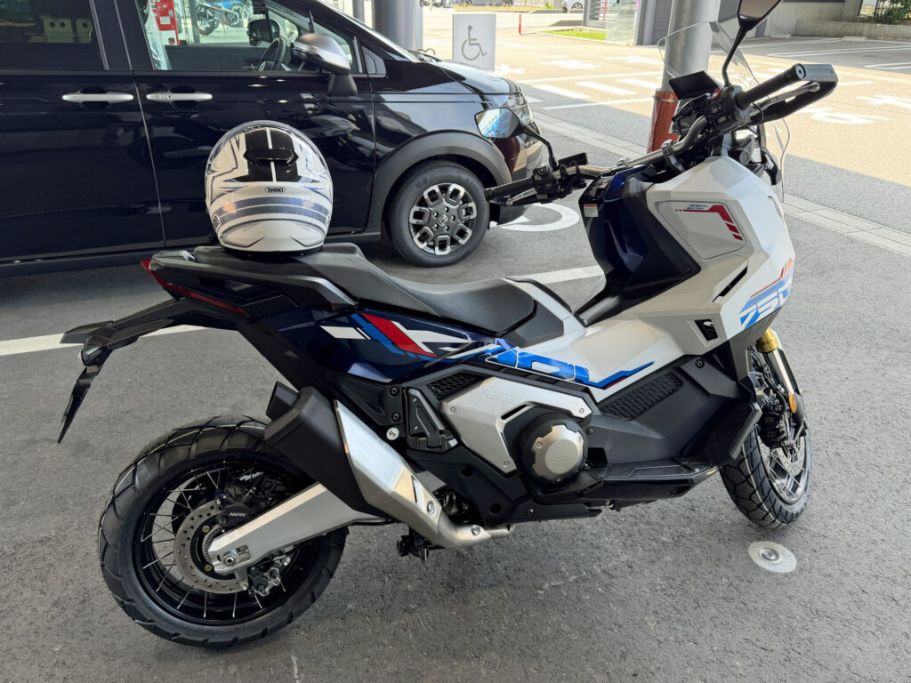 Right side full view of the Honda X-ADV 750 Special Edition in white, blue, and red tricolor graphics, showcasing its adventure scooter styling.
