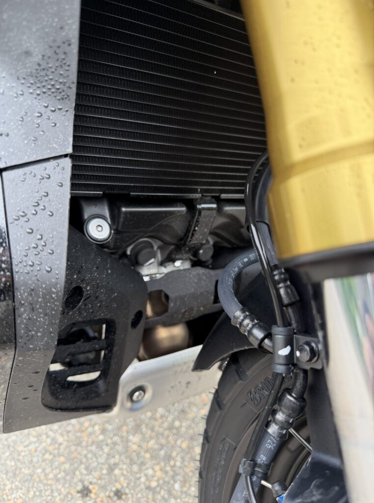 The inner plastic panel and radiator surroundings of a Honda X-ADV motorcycle, dirtied by front tire spray.