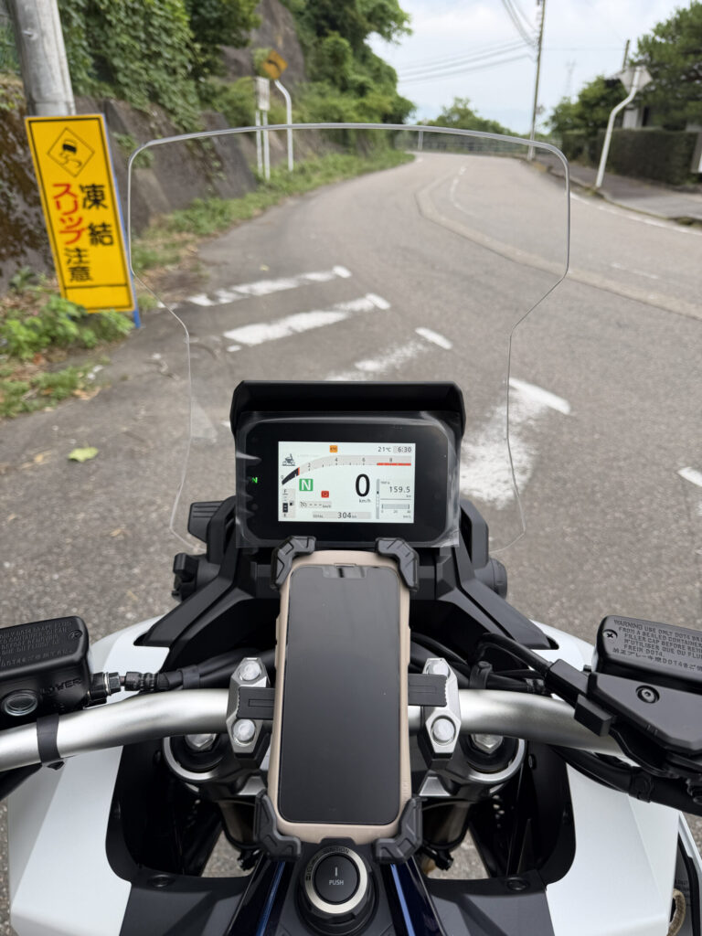 Cockpit view of a Honda X-ADV with the OEM windscreen set to the 4th step position.