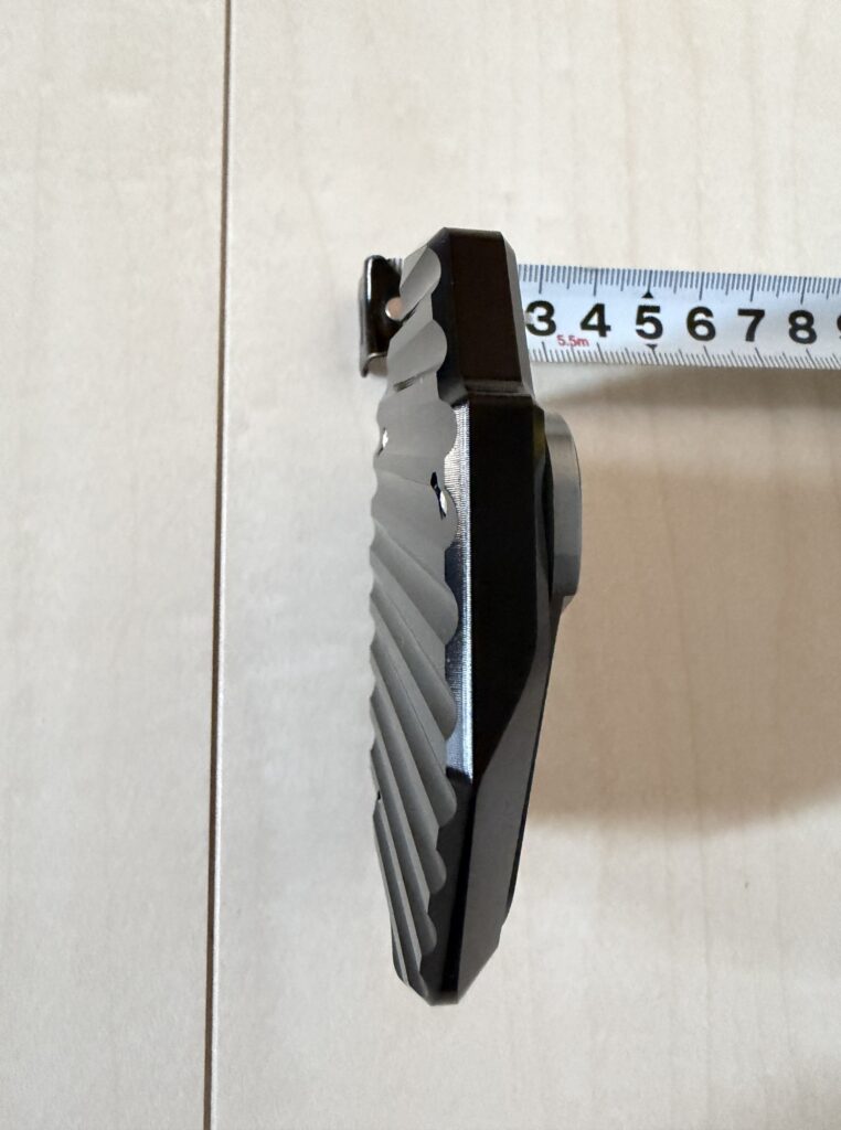 Side view of a motorcycle side stand extension plate for Honda X-ADV, measuring the thickness with a tape measure.