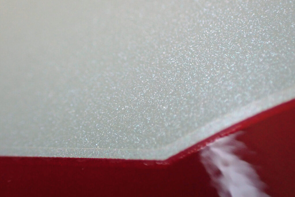 Extreme close-up of the sharp body line and pearl white paint on a Honda X-ADV cowl, highlighting the smooth gloss finish of the protective coat.