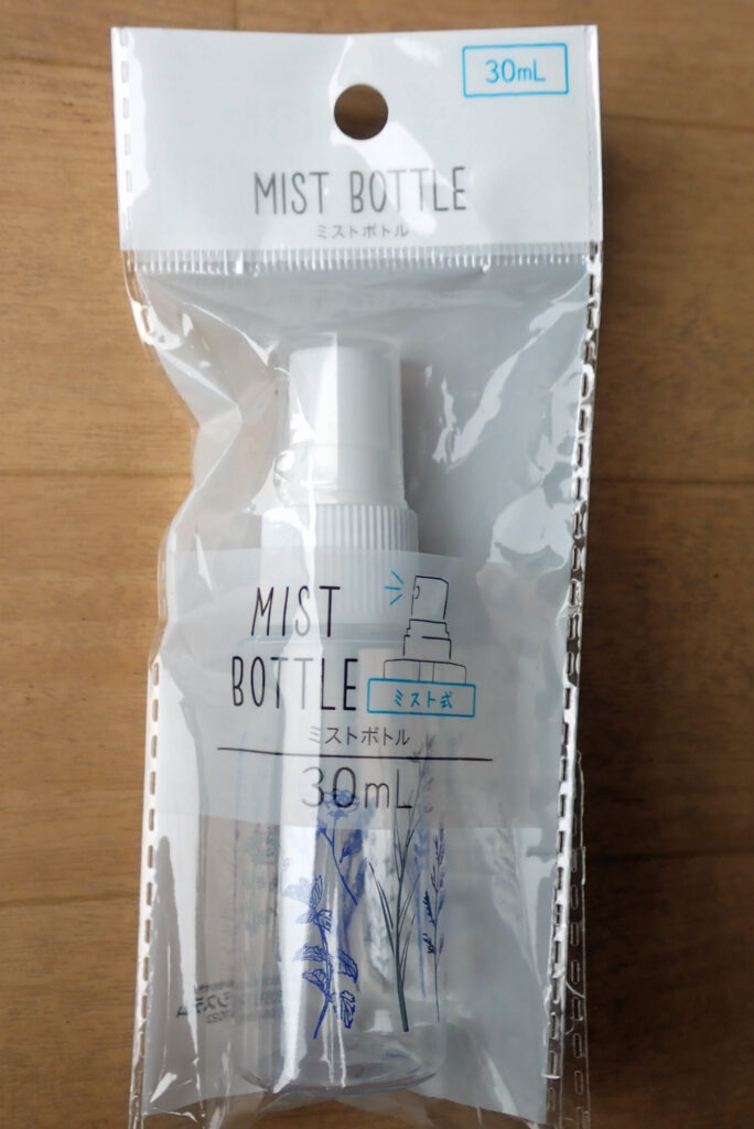 A affordable 30mL clear plastic mist spray bottle purchased from a 100-yen shop, packaged and ready for wet film installation solution.