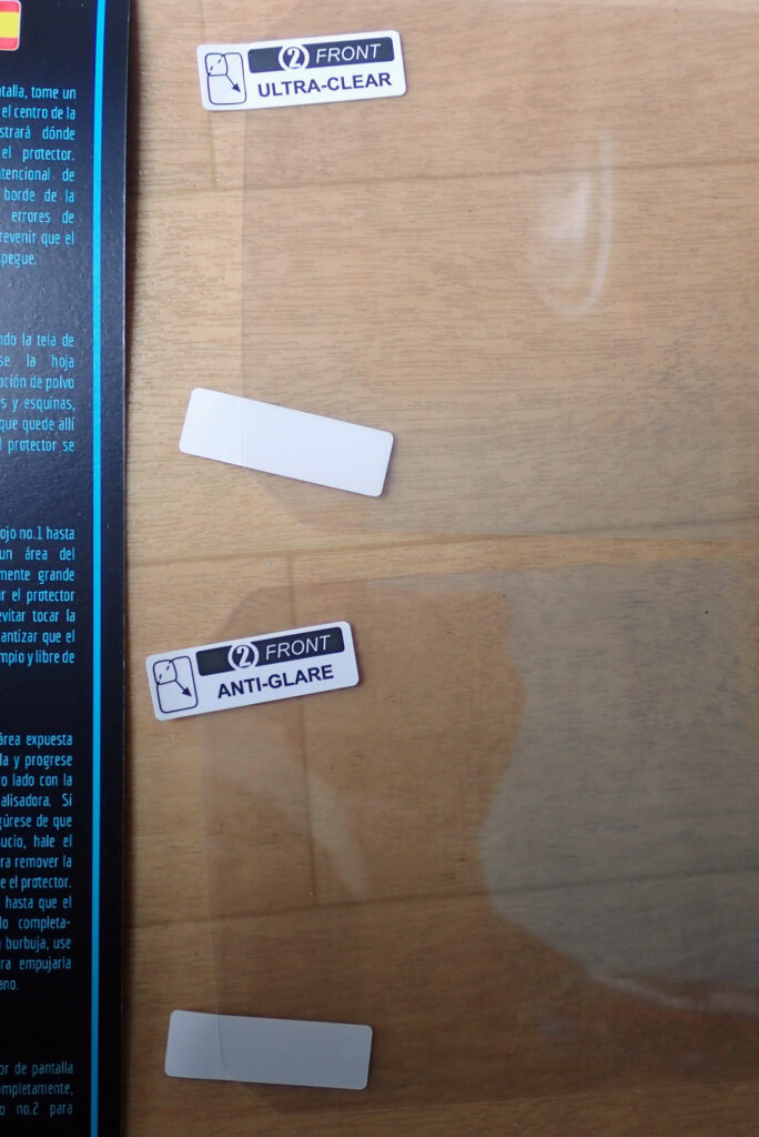 A comparison side-by-side view of the two enclosed screen sheets with pull tabs labeled Front Ultra-Clear and Front Anti-Glare.