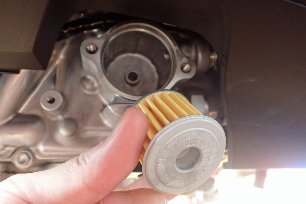 An inner look at the empty Honda dual-clutch transmission oil filter housing chamber on the right side engine case.