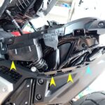 Side view of the exposed Honda X-ADV rear subframe showing grommet ports and sliding slot holes after removing the body panel.