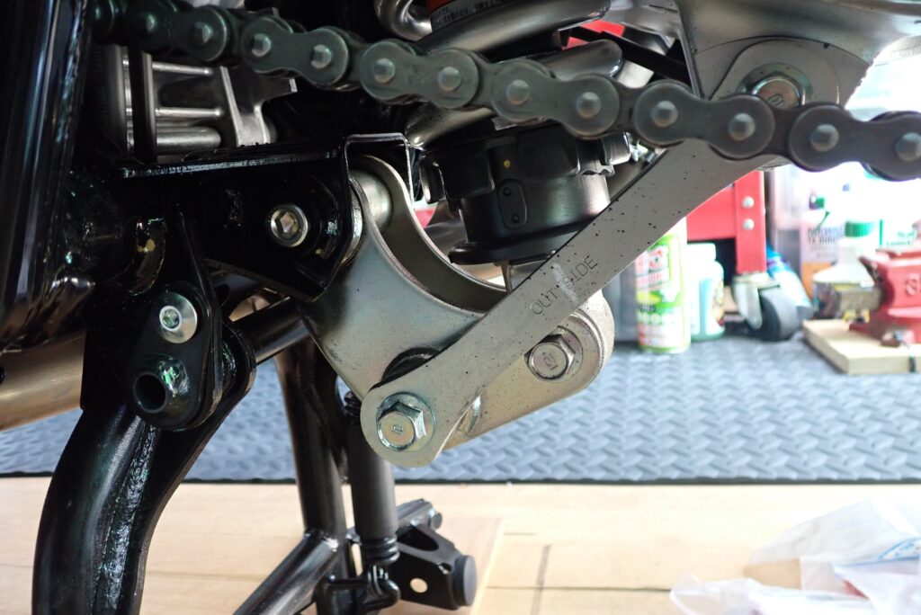 Close-up view of the rear monoshock absorber and Pro-Link suspension linkage mechanism under a Honda X-ADV.