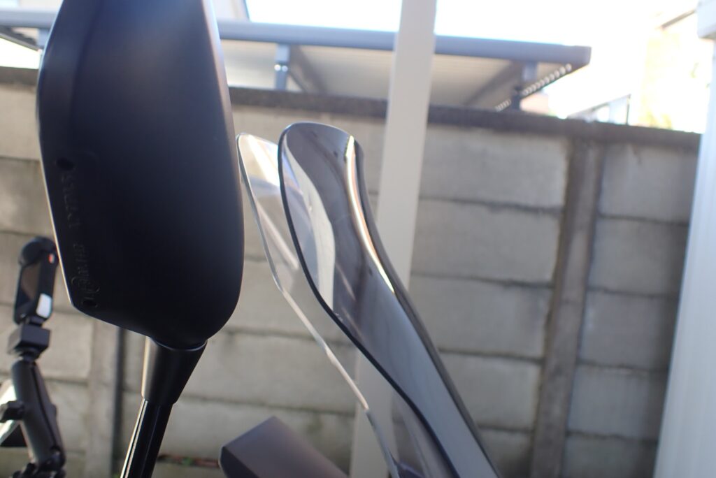 Side view comparing the profiles of the original Honda X-ADV screen and a smoked screen, highlighting the upward flipped spoiler edge.