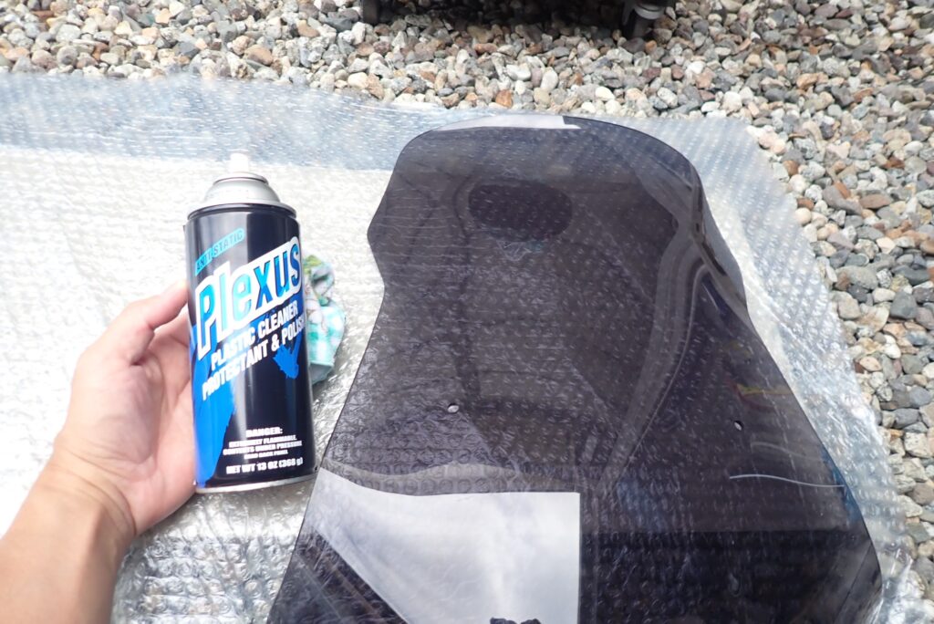 Cleaning aftermarket windscreen with Plexus plastic cleaner and polish spray