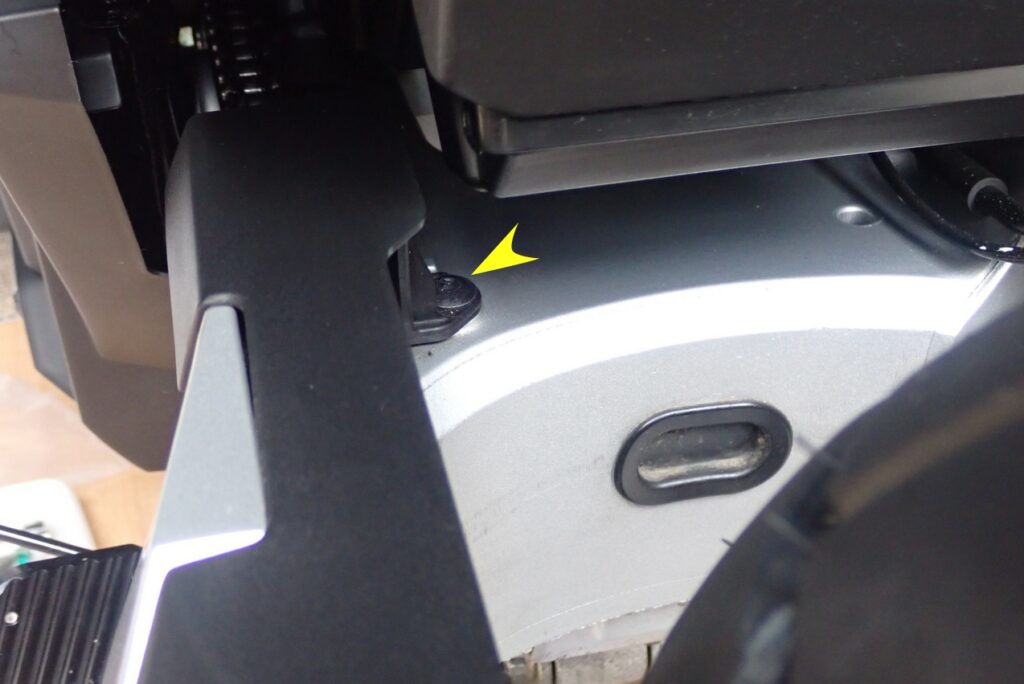 Close-up of the upper stock chain guard bolt on Honda X-ADV which does not need to be removed during Puig splash guard fitting.