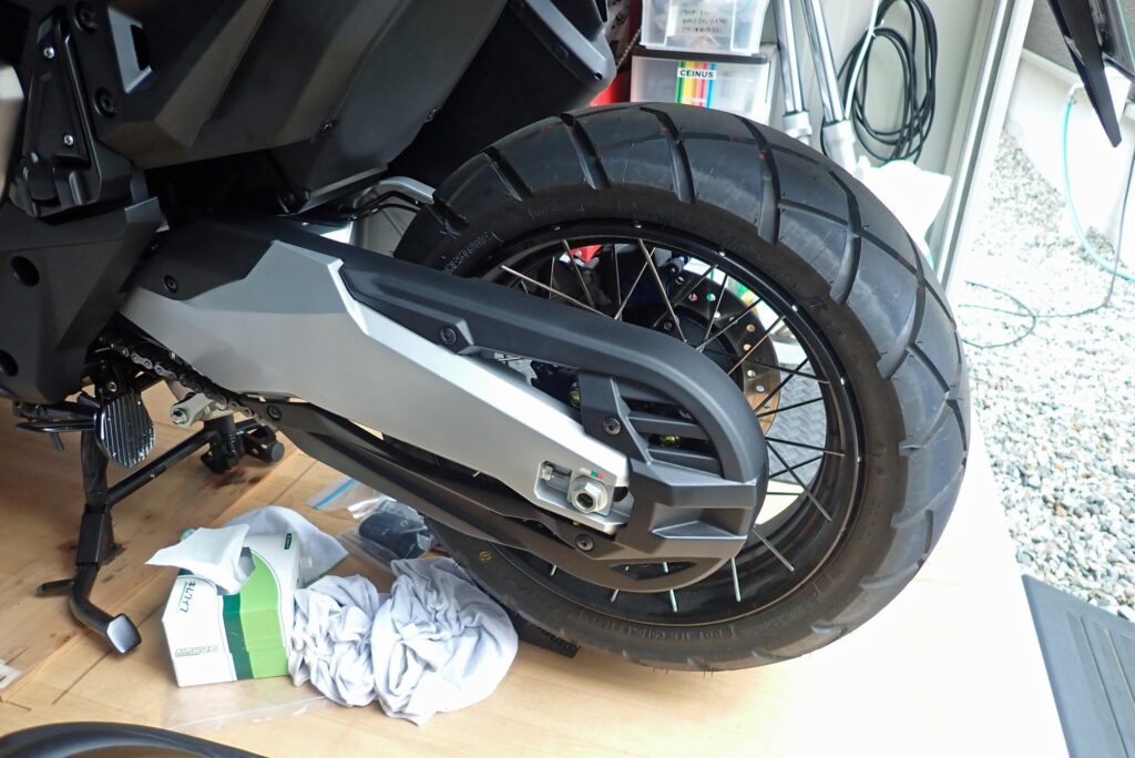 Stock rear wheel and swingarm of a Honda X-ADV before installing the Puig rear splash guard.