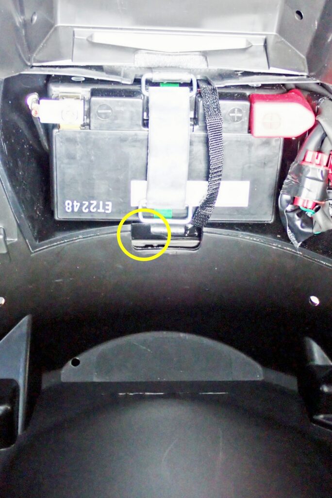 Wiring pass-through slot located under Honda X-ADV battery compartment