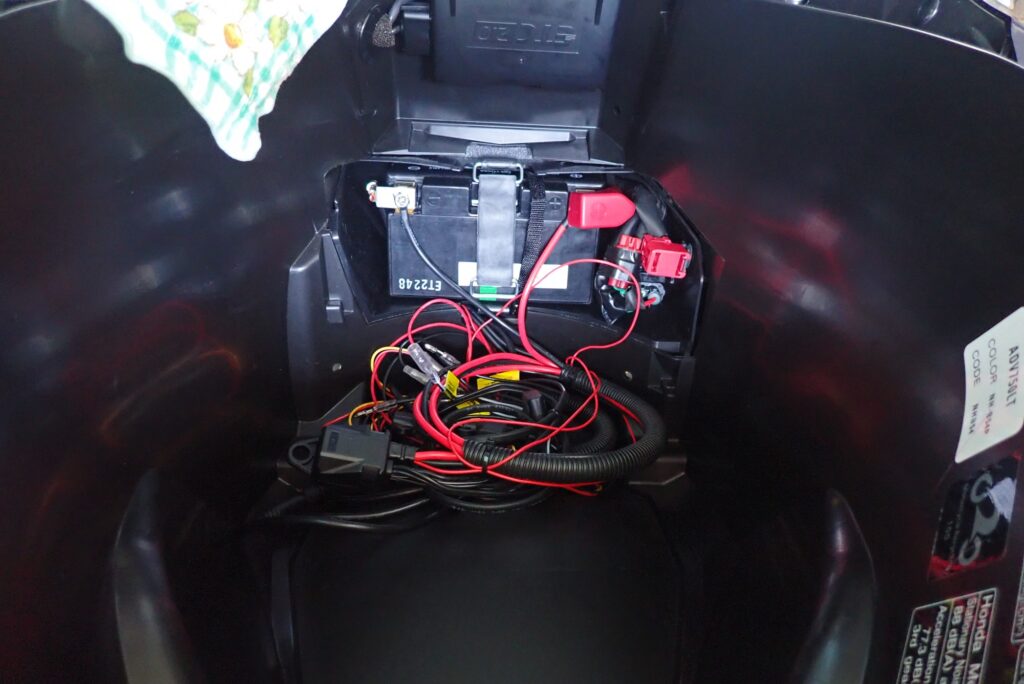 Completed installation showing Daytona D-UNIT and wiring harnesses bundled in Honda X-ADV underseat luggage box