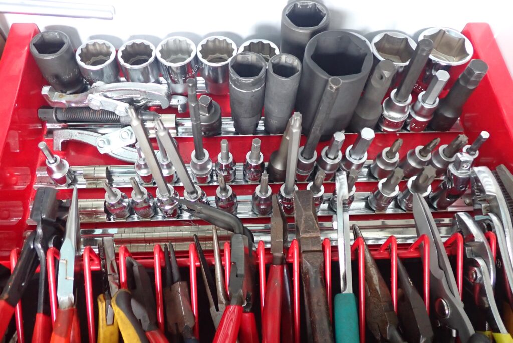 Motorcycle DIY mechanic tool drawer showing socket sets and quality tool collection