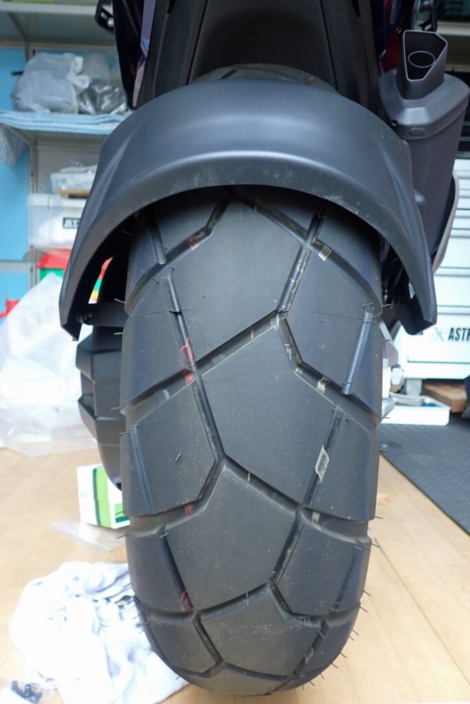 Direct rear view showing the Puig splash guard perfectly centered over the Honda X-ADV block pattern rear tire.