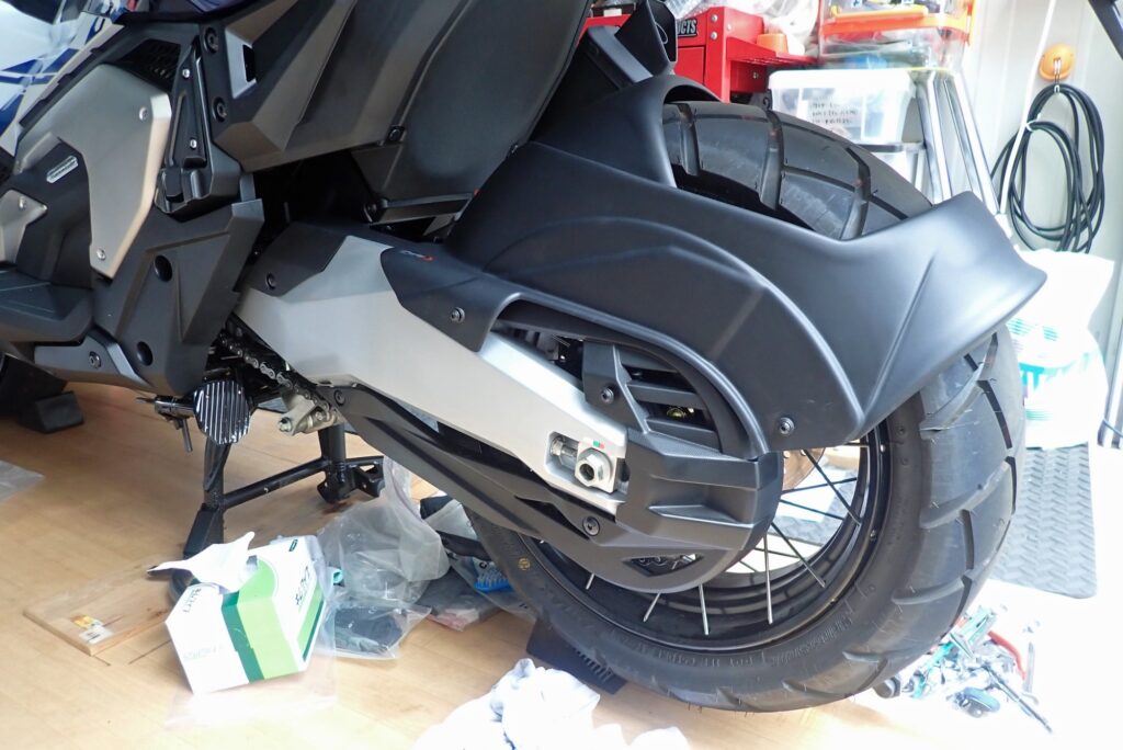 Left side view of the Puig splash guard body temporarily bolted onto the right main support bracket.