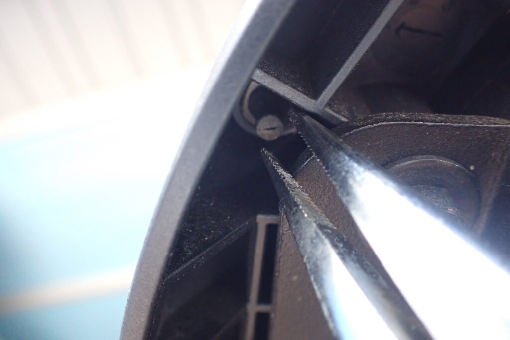 Pulling GIVI rubber damper stem from underneath using needle-nose pliers