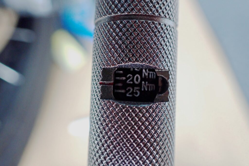 Close-up of the torque wrench micrometer scale set precisely to 22 Nm for Honda X-ADV rear brake caliper bolt specification.