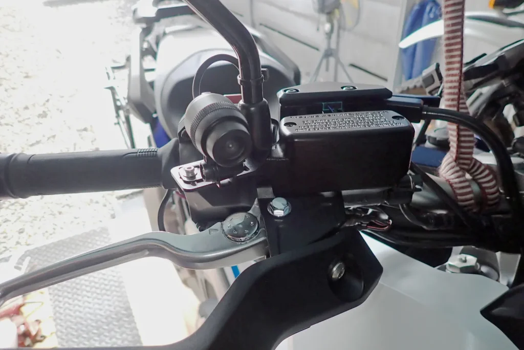 Front view of Daytona M820WD dashcam front camera mounted on Honda X-ADV