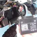 Discharged YTX5L-BS 12V motorcycle battery completely removed from the frame