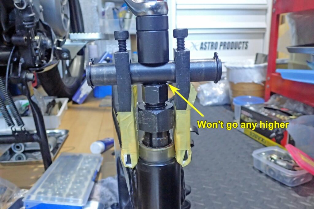 The bearing puller has reached the end of its travel, and the pulling has stopped part-way