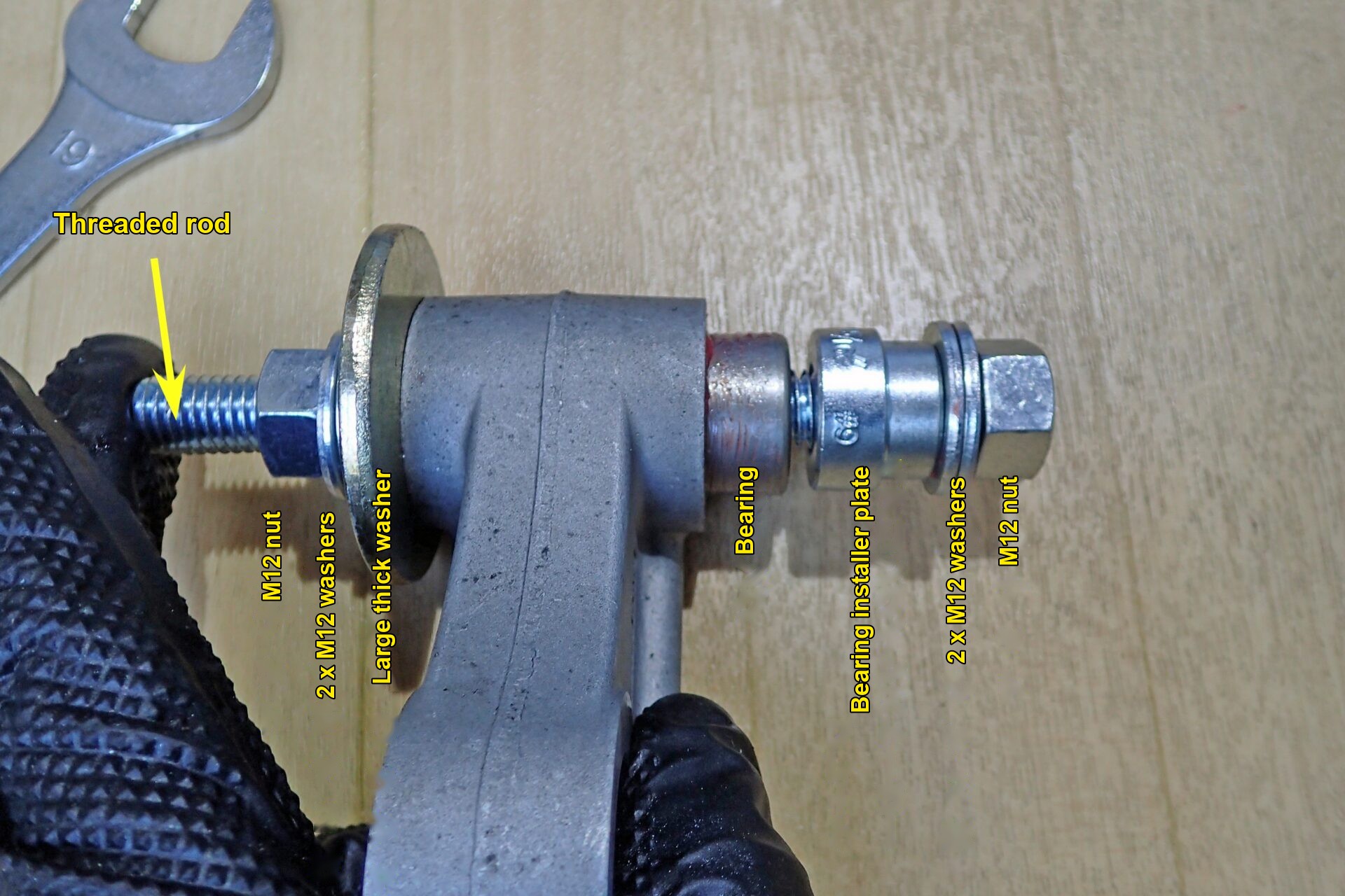The threaded rod, nuts, washers and installer plate set up to press in a bearing.