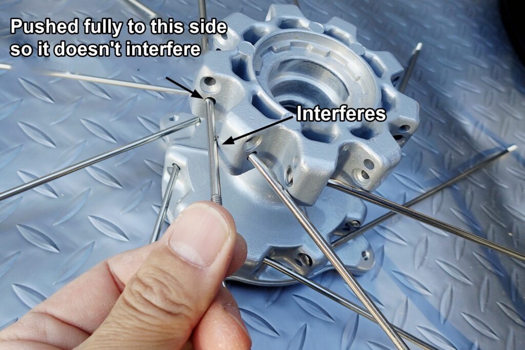 Protecting the spots where the thicker DACHI stainless spokes touch the powder-coated hub with paper