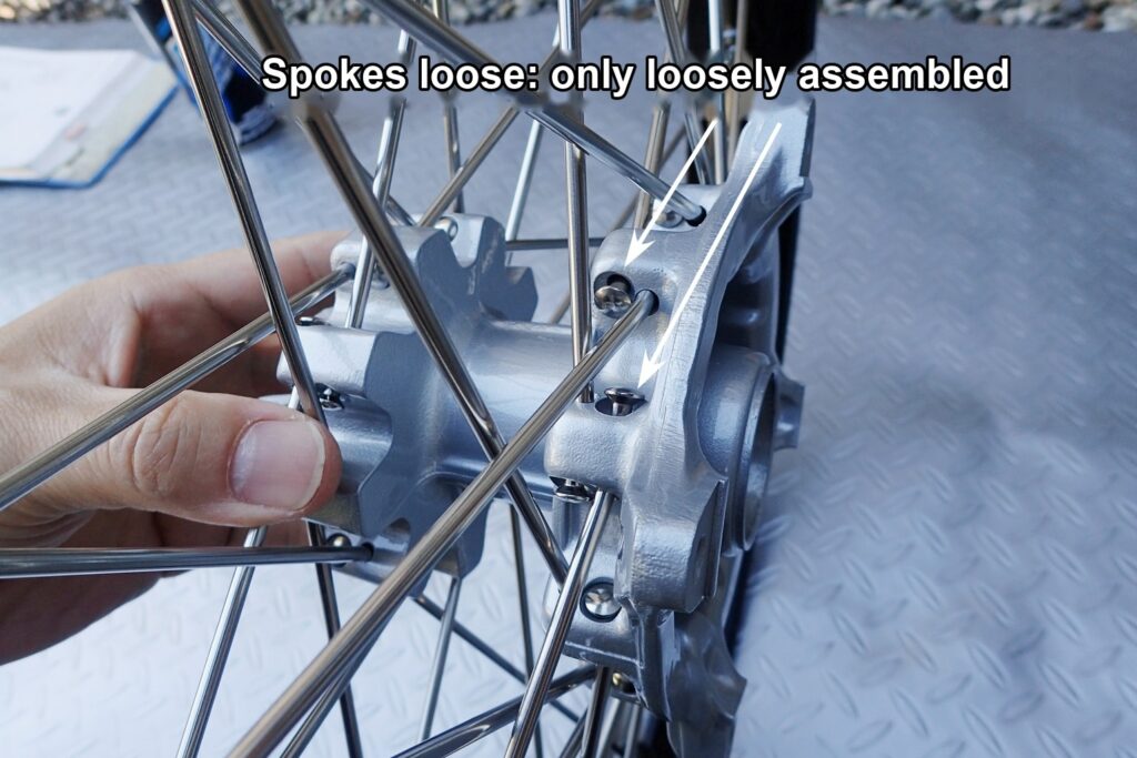 The loosely assembled wheel: the spokes are slack and the hub moves from side to side