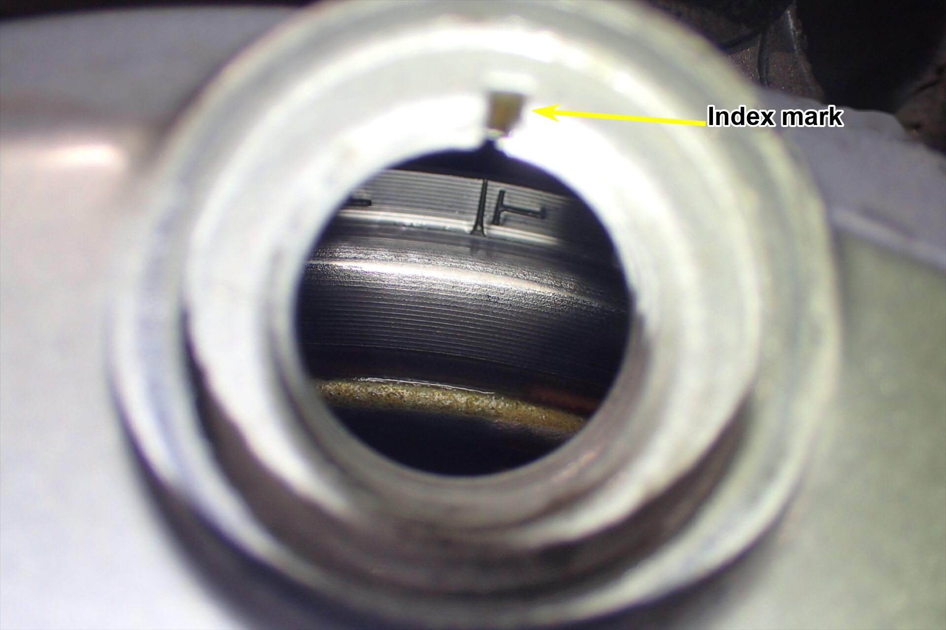 The flywheel T mark lined up with the index mark in the timing hole, with the XR250 at compression top dead centre.